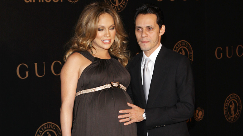 Marc Anthony with hand on Jennifer Lopez' stomach