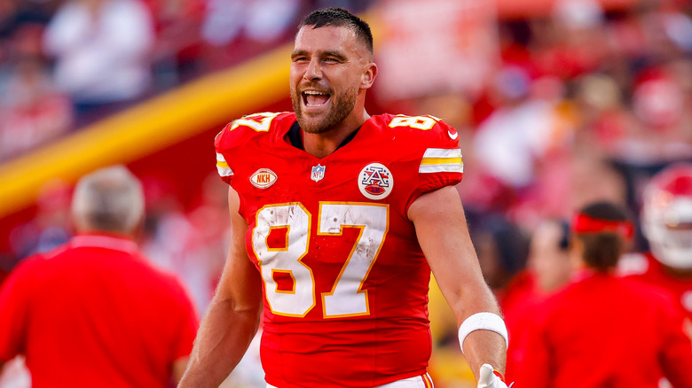 Travis Kelce smiling big on football field