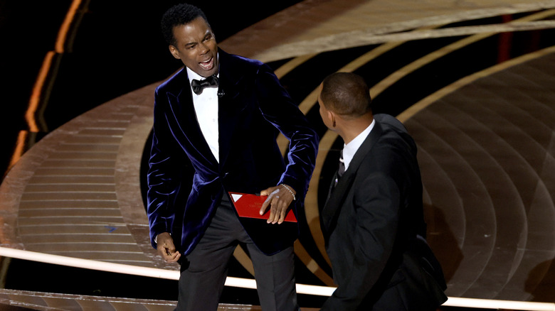 Will Smith slaps Chris Rock on stage at the 2022 Oscars