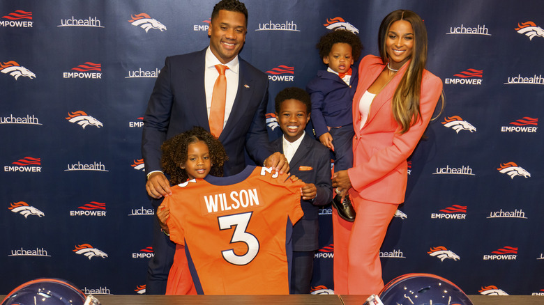 Russell Wilson and his family with his Broncos jersey