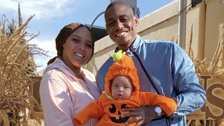 Charmaine Bey posing with baby Nola and husband Neek Bey