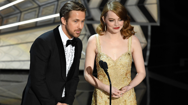 Ryan Gosling and Emma Stone behind a mic