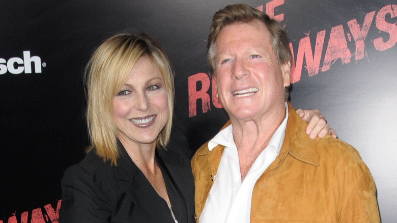 Tatum O'Neal stands with an arm around Ryan O'Neal