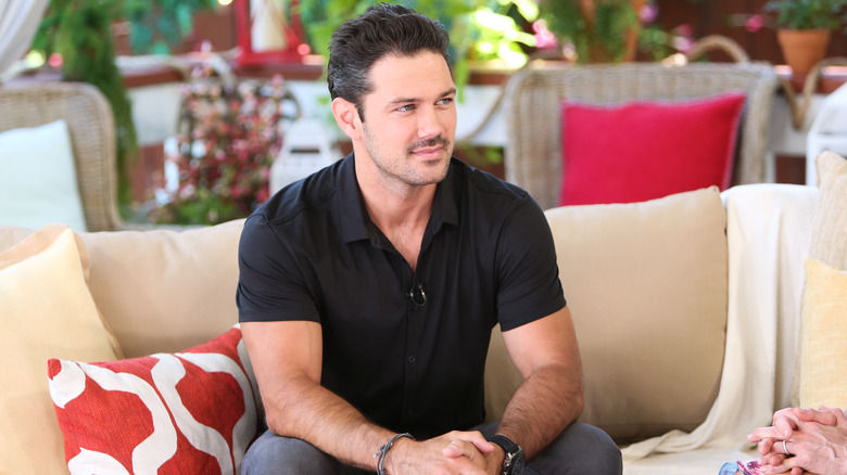 Ryan Paevey on a sofa