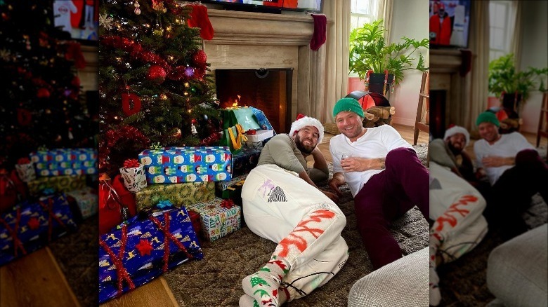 Matt Sinn lays beside Ryan Phillippe underneath a Christmas tree