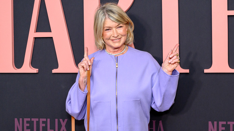 Martha Stewart pointing at the sign for the Netflix documentary about her