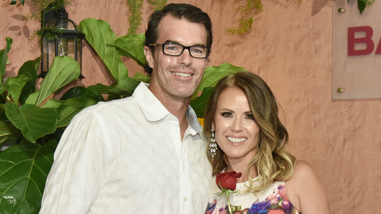 Ryan and Trista Sutter posing at an event 