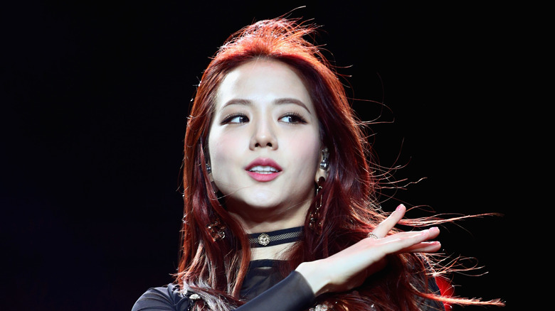 Blackpink member Jisoo posing during performance stares off camera