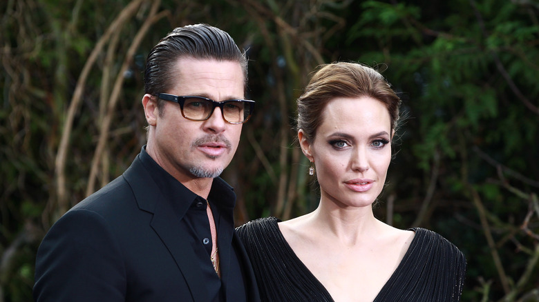 Brad Pitt and Angelina Jolie pose in black outfits