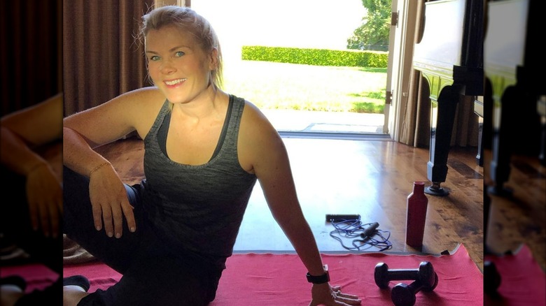 Alison Sweeney seated on floor with workout gear