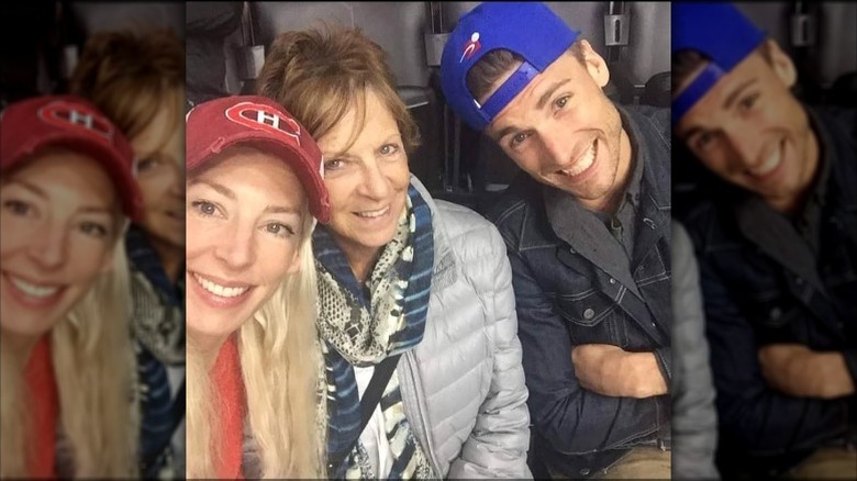 Andrew Walker smiles with his mother and sister