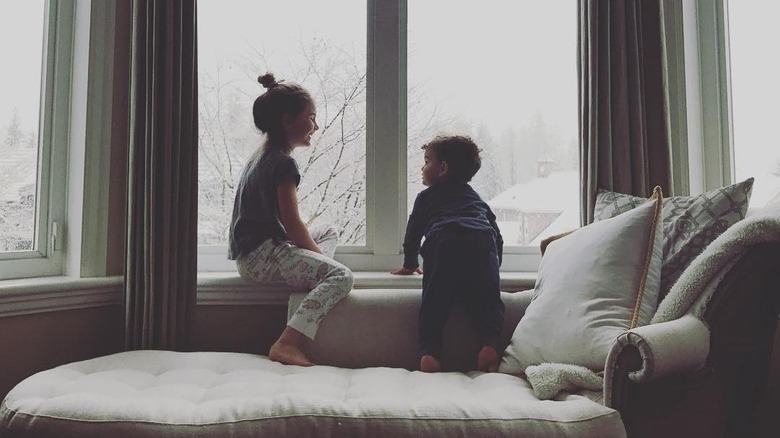 Erica Cerra's children sit together by a window