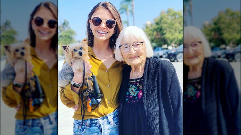 Aimeé Teegarden posing with her dog Gizmo and grandmother Verla Brining.