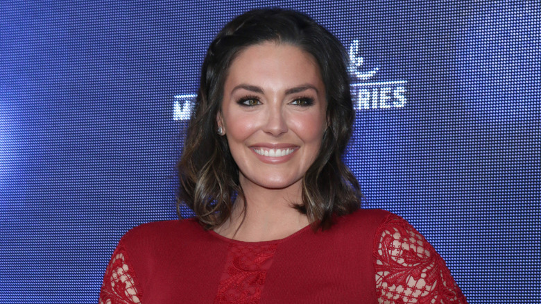 Taylor Cole wearing a red dress