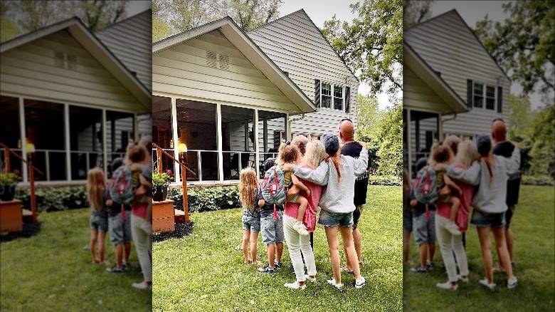 Jenn Todryk and family in front of house