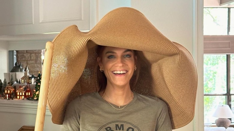 Jenn Todryk smiles in oversized hat