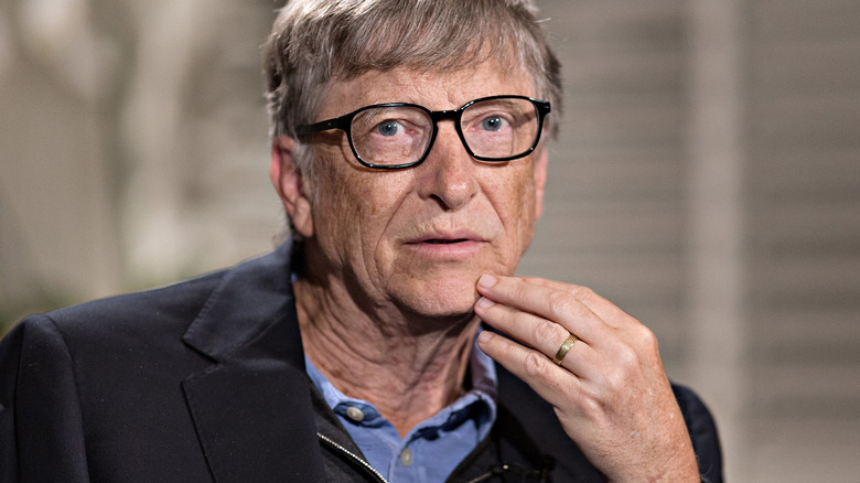 Bill Gates with his hand to his face