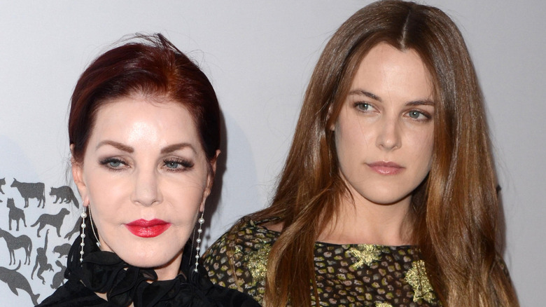 Priscilla Presley and Riley Keough, looking away