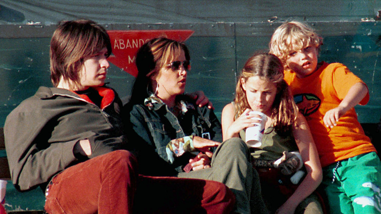 A young Riley Keough with family, all seated, looking away