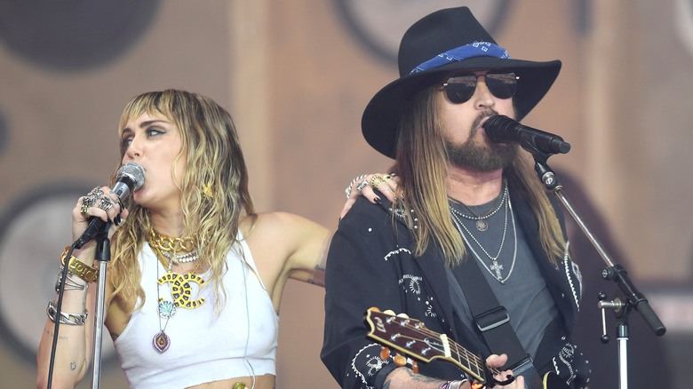 Miley and Billy Ray Cyrus performing