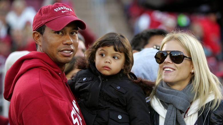 Tiger Woods, Sam Alexis Woods, and Elin Nordegren smiling in 2009