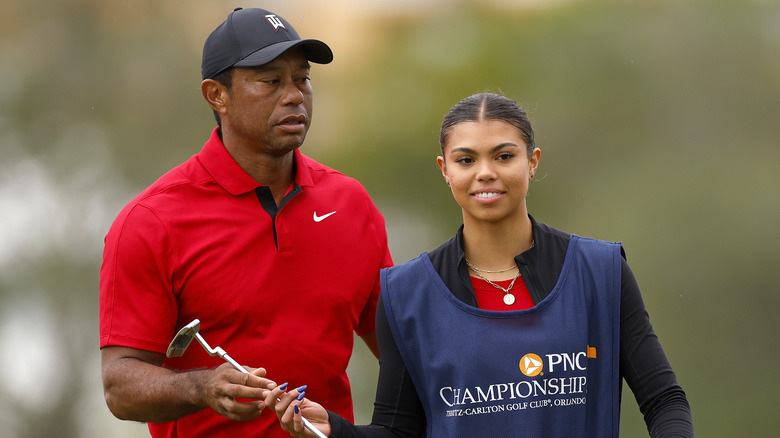 Sam Alexis Woods caddying for father Tiger Woods