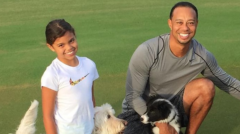 Sam Alexis Woods and Tiger Woods smiling