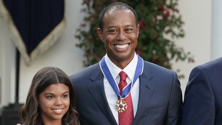 Sam Alexis Woods and Tiger Woods smiling