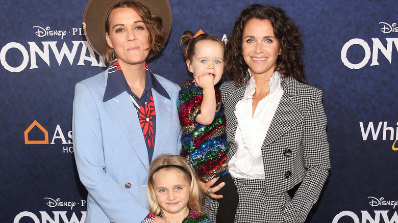 Brandi Carlile posing at an event with her wife and kids