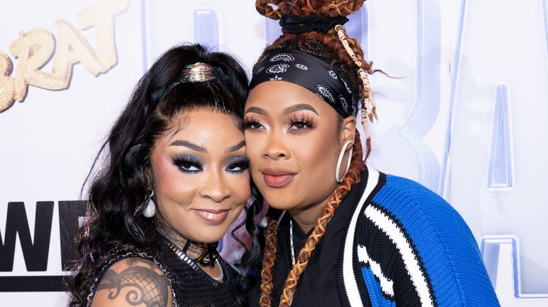 Da Brat and Jesseca Harris-Dupont embracing and posing 