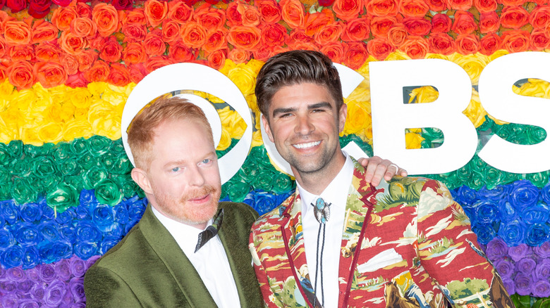 Jesse Tyler Ferguson and Justin Mikita posing at an event