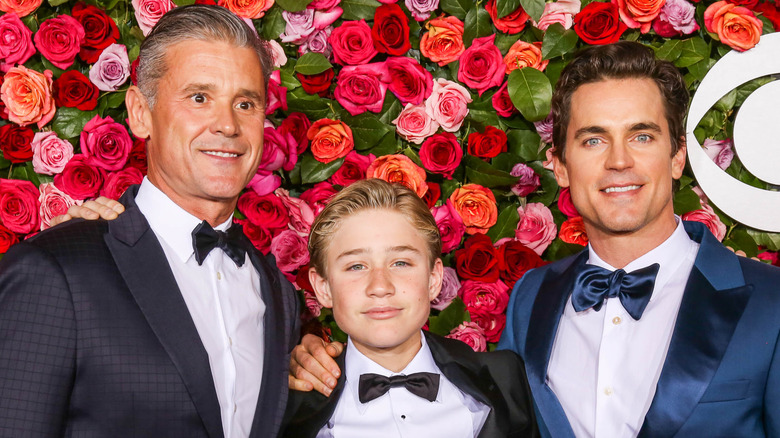 Matt Bomer, Kit Halls, and Simon Halls posing at an event