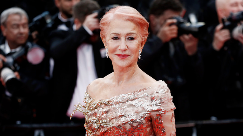 Helen Mirren poses with a sequined gown and pink hair at a movie premiere 