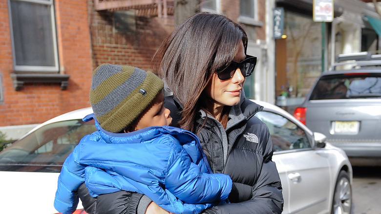 Sandra Bullock carries her son 