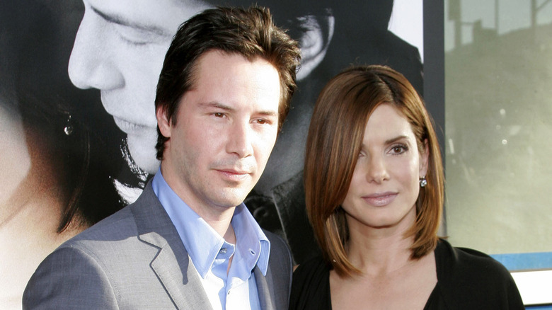 Keanu Reeves and Sandra Bullock posing at a 2006 event