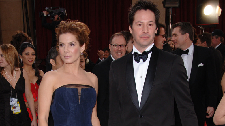 Sandra Bullock and Keanu Reeves on the red carpet in the '90s