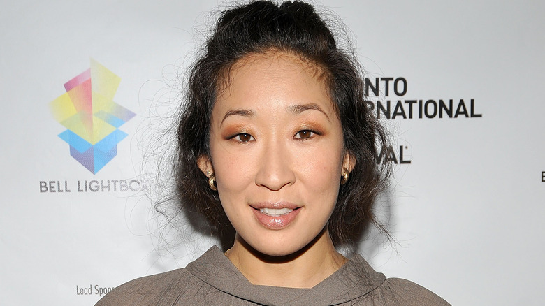 Sandra Oh posing with hair up