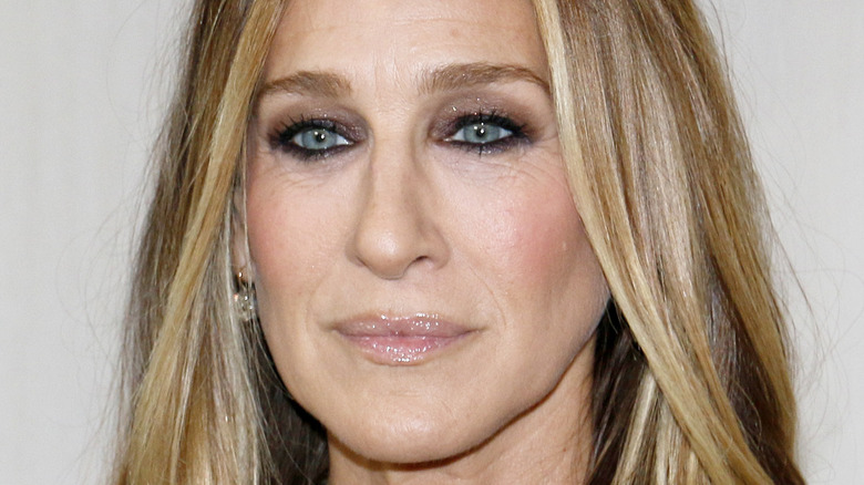 Sarah Jessica Parker smiles solemnly at an event