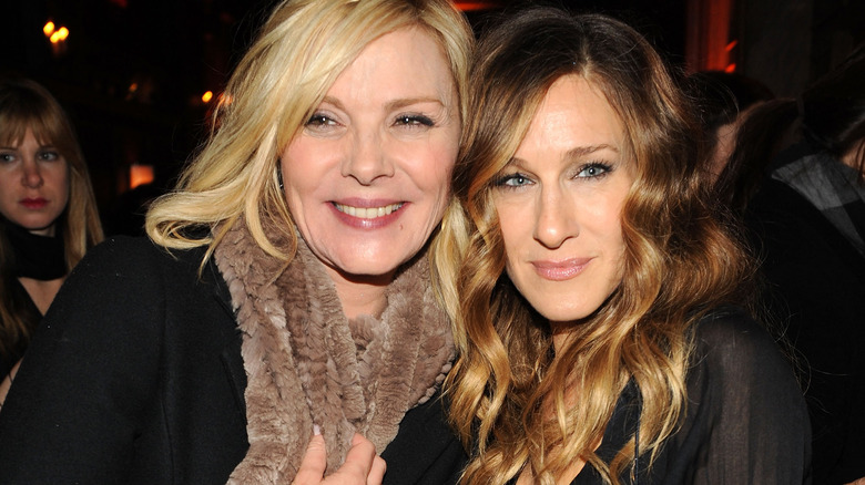 Kim Cattrall smiles alongside Sarah Jessica Parker at an event