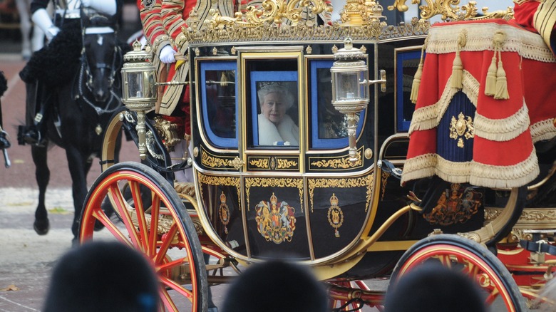 Queen Elizabeth riding the golden carriage