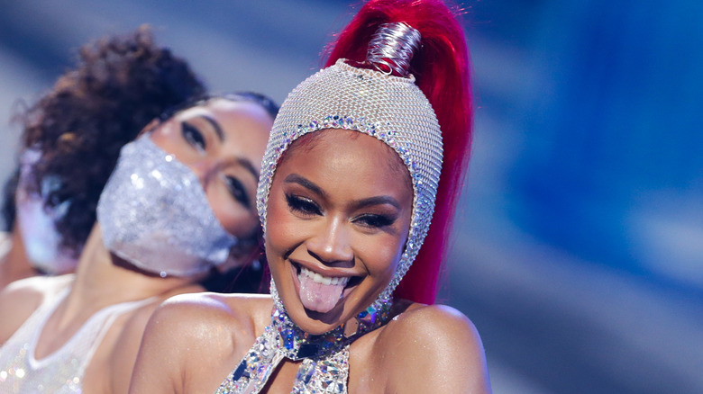 Saweetie laughing during a performance