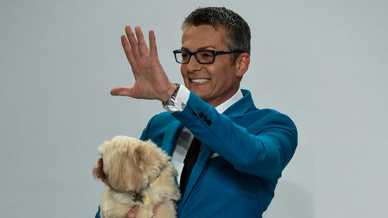 Randy Fenoli waves on the runway with dog