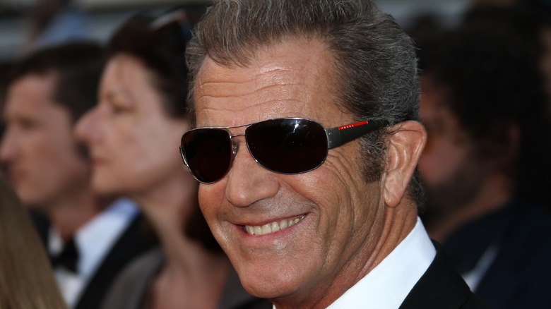 Mel Gibson smiling and wearing sunglasses