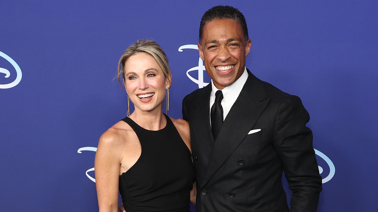 TJ Holmes and Amy Robach posing together