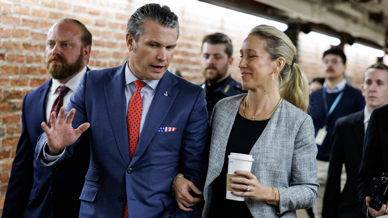 Pete Hegseth and Jennifer Rauchet leaving a meeting