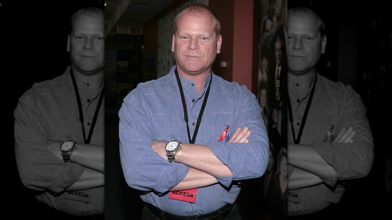 Mike Holmes with arms folded wearing a blue button-up shirt