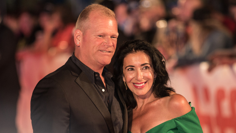 Mike Holmes and Anna Zappia gentle embracing and smiling