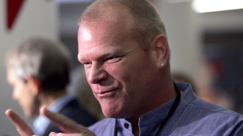 Mike Holmes smirking with two of his fingers pointed out