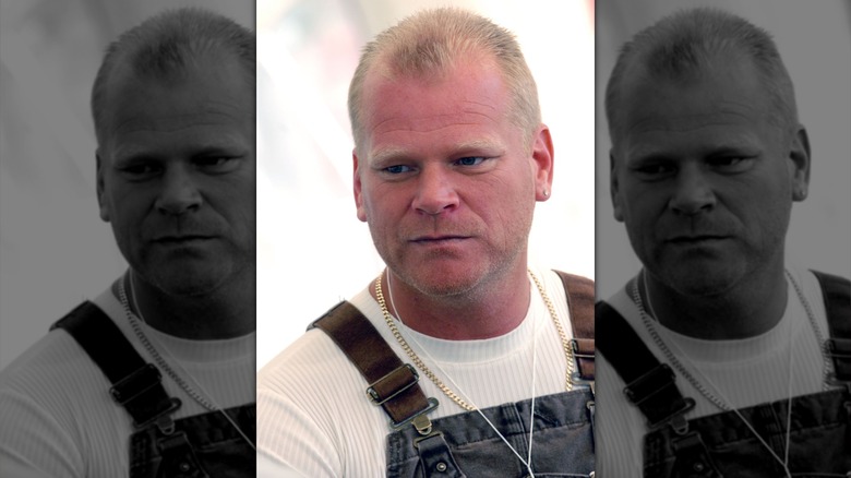 Mike Holmes looking glum while wearing a shirt shirt and overalls