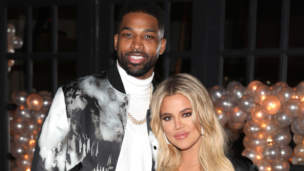 Khloe Kardashian and Tristan Thompson smiling at an event